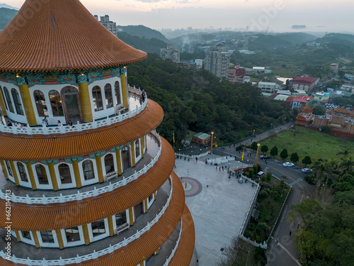 Aerial view of sunset at Wuji Tianyuan Temple by drone in Tamsui, New Taipei City, Taiwan. Beautiful weather, blue sky and mountains. photo