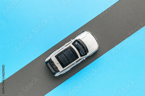 Photos Top view of a white car moving along a gray road on a blue background