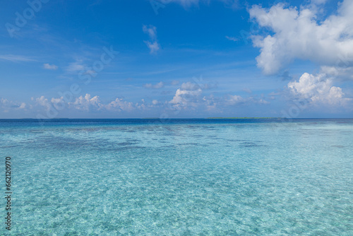 Indian Ocean, beautiful calm turquoise water and blue sky with few clouds. Tropical beach panorama, seascape with wide horizon. Skyscape sunny inspirational exotic sea surface. Climate ecology concept © icemanphotos