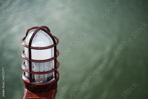 Solar Lantern and electrical lamp near the garden and river. Technology lighting concept