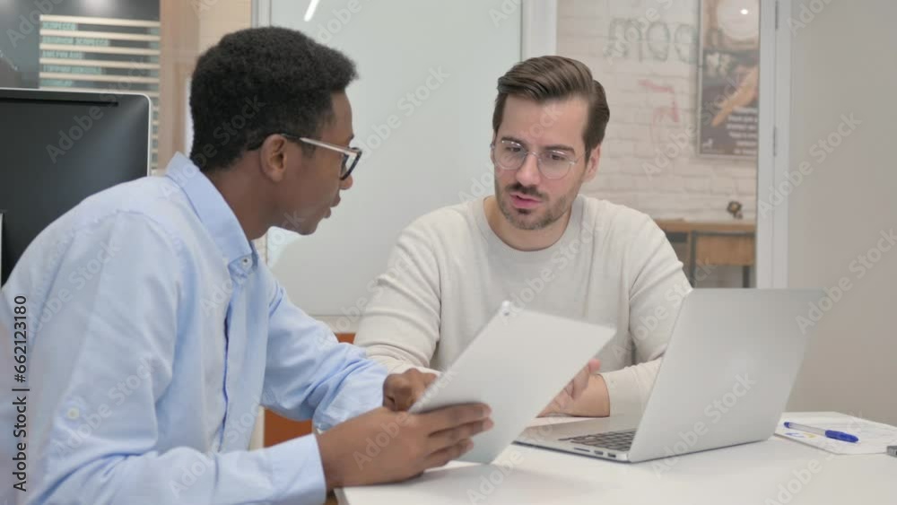Business People Working on Laptop and Tablet in Office Business People Working on Laptop and Tablet in Office