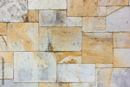 Texture of the brown and white wall made of square stone tile bricks or palimanan wall, dirty photo