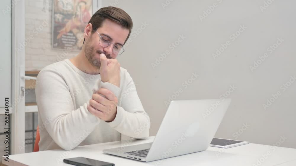 Middle Aged Man having Wrist Pain in Office Middle Aged Man having Wrist Pain in Office