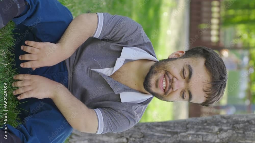 Vertical Video of Outdoors teenager taking deep breaths with happy expression.