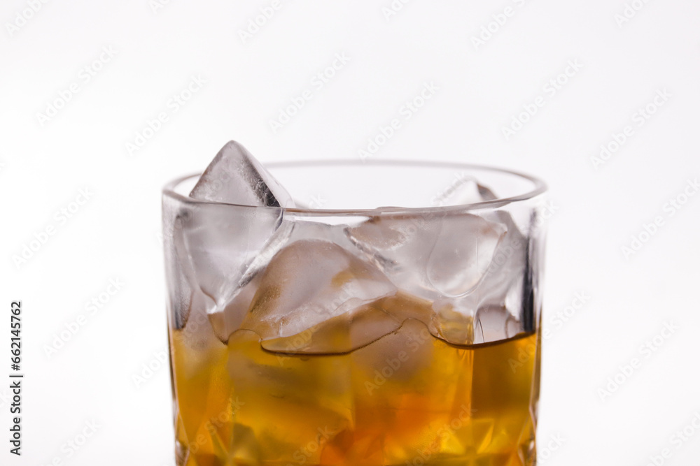 whiskey in a glass filled with ice cubes whiskey in a glass filled with ice cubes