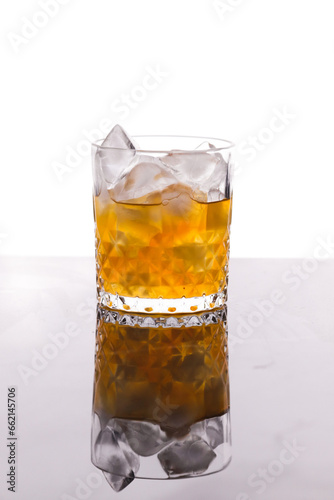 whiskey in a glass filled with ice cubes