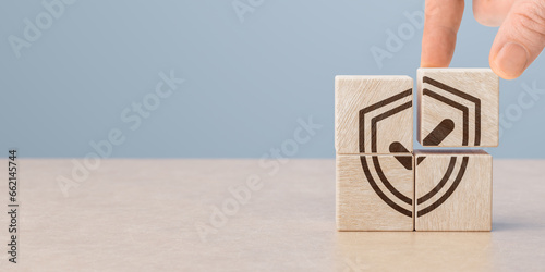 Protection health and life insurance concept. Care for employees. Hand puts wooden cubes with shield protect and tick mark. copy space.