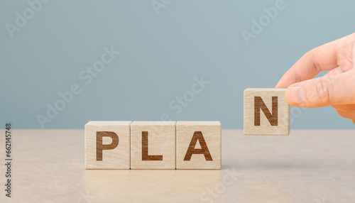 Fototapeta Naklejka Na Ścianę i Meble -  plan background. hand puts out cubes with letters plan. Cubes with text plan. to do list and plan. Development to success and motivation. copy space