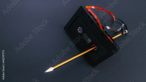 Rewinding a cassette tape manually with a pencil. Creativity concept. 80's and 90's.1