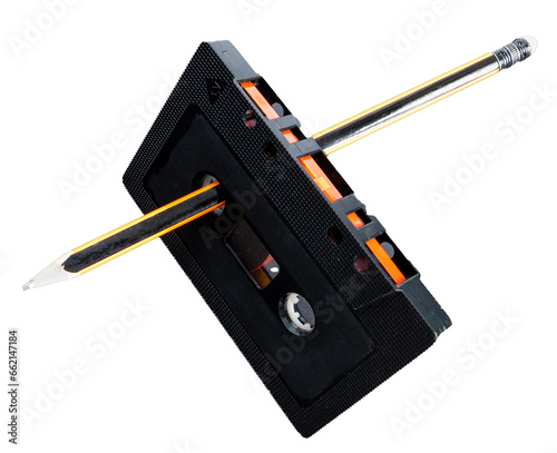 Rewinding a cassette tape manually with a pencil. Creativity concept. 80's and 90's.4