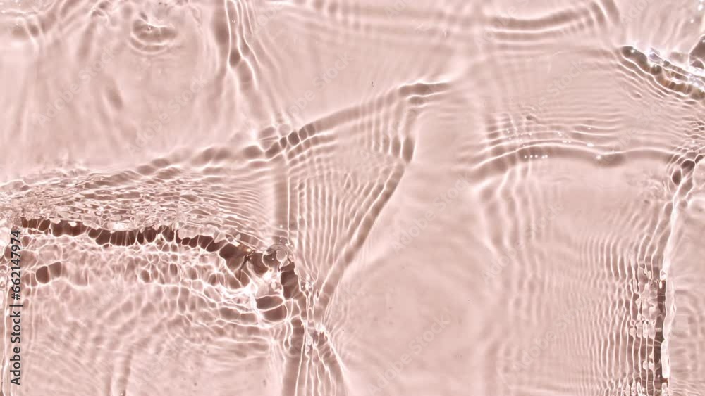 Pure pink water with reflections sunlight in slow motion. Water surface texture. Sun and shadows. Motion clean swimming pool ripples and wave. High quality 4k footage Pure pink water with reflections sunlight in slow motion. Water surface texture. Sun and shadows. Motion clean swimming pool ripples and wave. High quality 4k footage