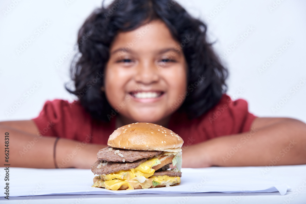 A little girl with an appetizing burger, Close-up focus on Burger A little girl with an appetizing burger, Close-up focus on Burger
