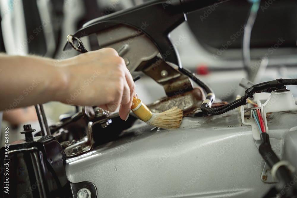 Obraz premium Worker make dry cleaning the car interior using a special brush with foam