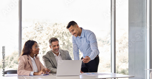 Happy business people executive team working at laptop using computer having discussion at office professional meeting showing financial project results consulting client investor at workplace.