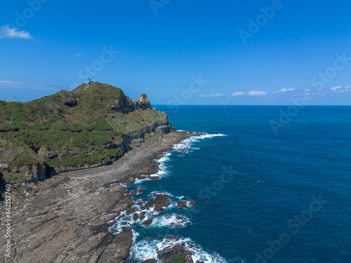 Aerial view of Bitoujiao lighthouse, a famous scenery of Taiwan northeast corner. Birds eye view in Bitoujiao cape, Ruifang district, New Taipei, Taiwan. photo