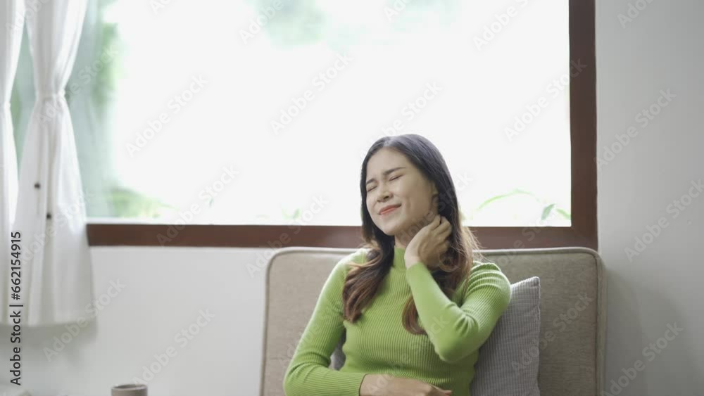 Relaxed young Asian woman enjoying relaxation on a comfy sofa at home. Calm, relax and breathe fresh air in the house, concept of balance and tranquility. Relaxed young Asian woman enjoying relaxation on a comfy sofa at home. Calm, relax and breathe fresh air in the house, concept of balance and tranquility.