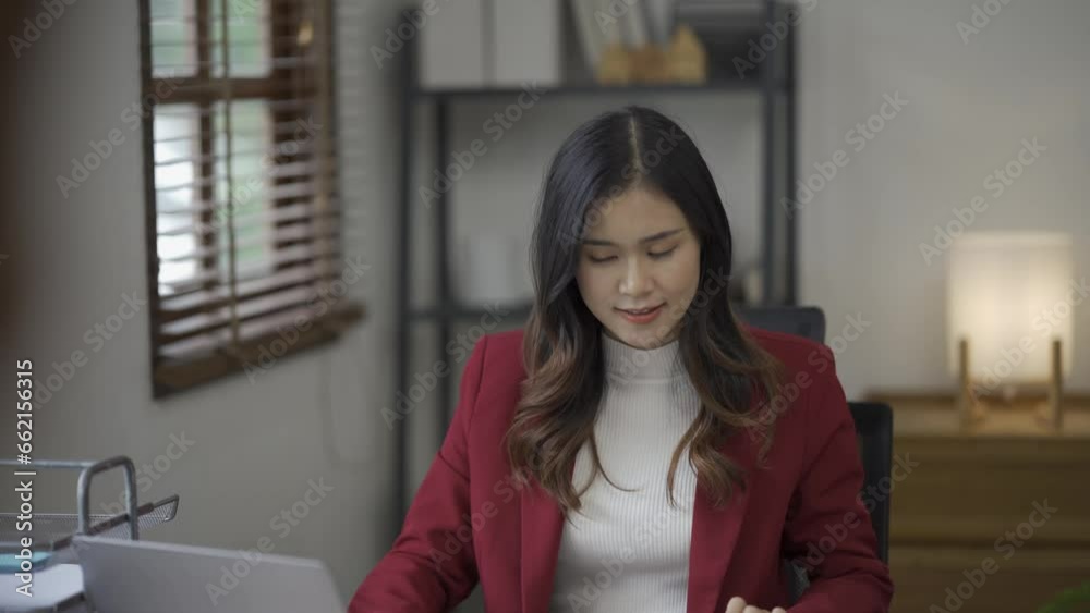 Cheerful smiling Asian woman, attractive female accountant in casual clothes, busy working with documents, charts, paper, laptop in office, successful businesswoman in finance Cheerful smiling Asian woman, attractive female accountant in casual clothes, busy working with documents, charts, paper, laptop in office, successful businesswoman in finance