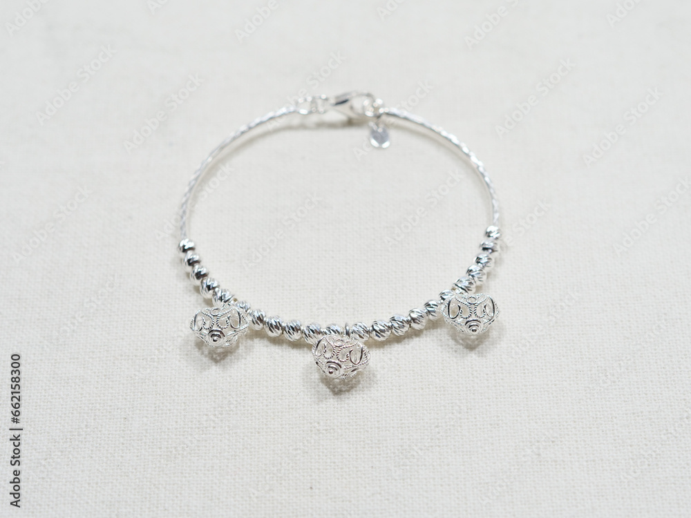 Silver bracelet display on white cloth background Silver bracelet display on white cloth background