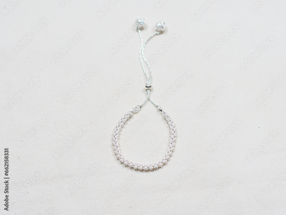 Silver bracelet display on white cloth background