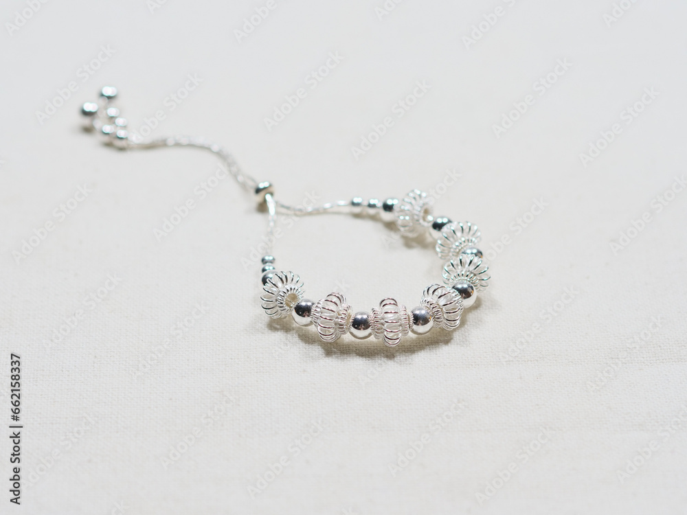 Silver bracelet display on white cloth background Silver bracelet display on white cloth background