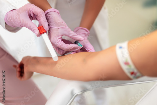 Nurse takes blood from the patient's hand