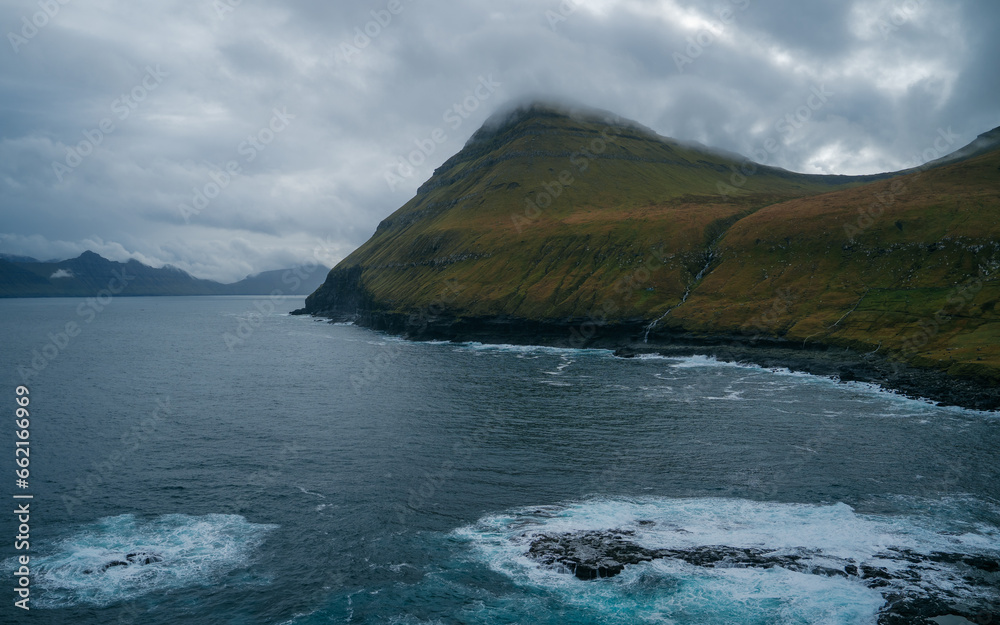 Impression of the wild Faroe coast in the North Atlantic. Paralyzing cliffs Impression of the wild Faroe coast in the North Atlantic. Paralyzing cliffs