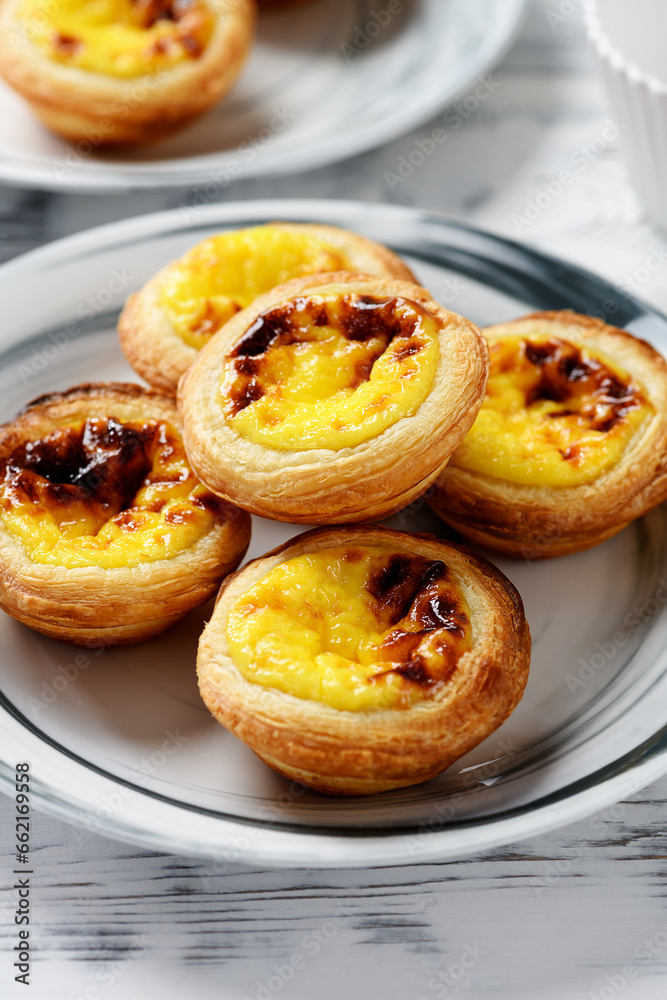 Pastel de nata or Portuguese egg tart. Small tart with a crispy puff pastry crust and a custardy pastry cream filling Pastel de nata or Portuguese egg tart. Small tart with a crispy puff pastry crust and a custardy pastry cream filling