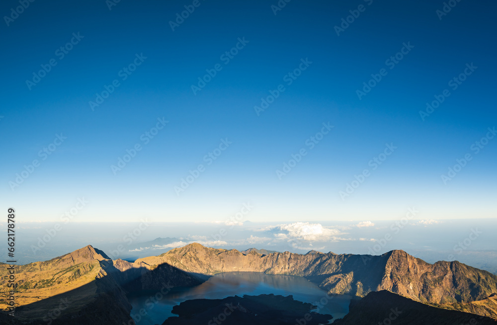 Mount Rinjani crater and lake view from summit at sunrise, Lombok, Indonesia. Rinjani is the second highest active volcano in Indonesia