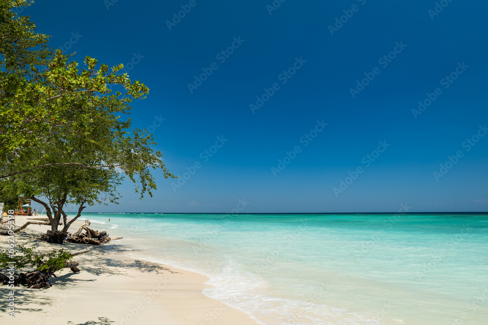 Tropical sandy beach with turquoise ocean at Gili Trawangan, one of the Gili islands in Lombok, Indonesia