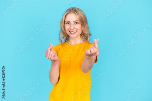 Smiling woman making love sign, shapes mini heart gesture