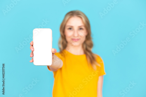 Selective focus on smartphone with empty screen holding by woman