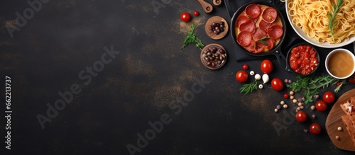 Italian cuisine featuring pasta pizza olives and antipasto on a flat surface with room for text With copyspace for text