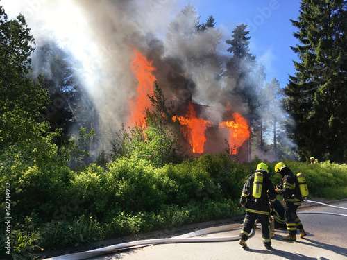 Firefighters put out burning house