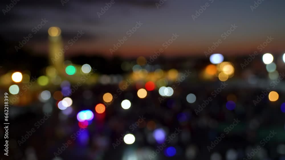 Jemma el Fnaa square in Marrakesh, Morocco at night is a vibrant market square with many people and motion. Out of focus and bokeh video done on purpose.