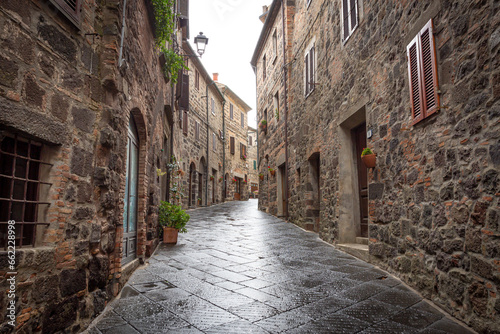 a narrow street with traditional houses in Radicofani, province of Siena, Tuscany, Italy photo