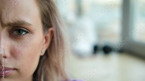 Canvas Print Close-up of a sad dissatisfied serious woman's face indoors