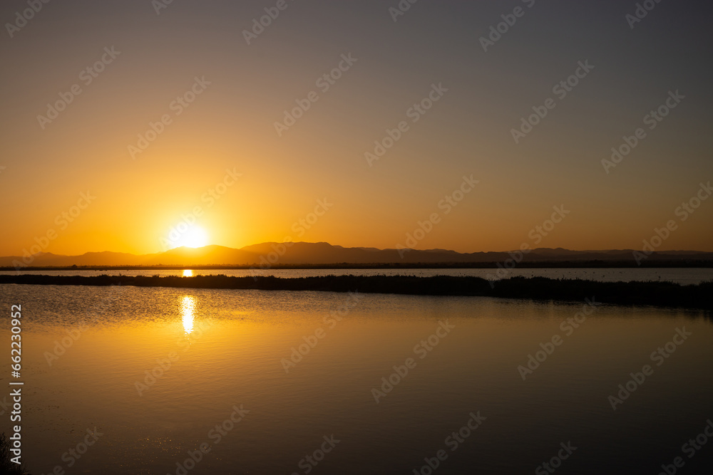 Golden sunset under the lake. Tranquility, beautiful landscape. Scenic landscape, twilight time, calm water.