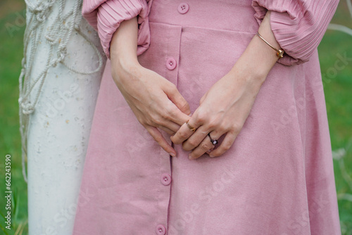 Woman holding her hand with pink dress
