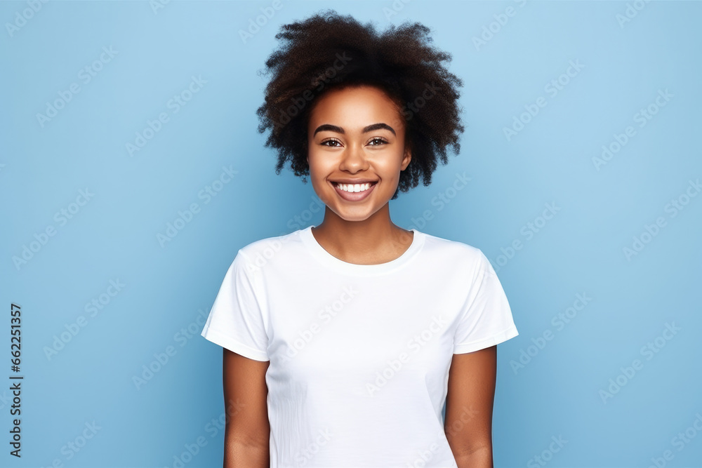 retrato mujer joven de raza negra con pelo afro  sonriente vistiendo camiseta blanca de manga corta  sobre fondo  azul claro con espacio vacio  - obrazy, fototapety, plakaty 