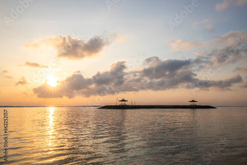 Landscape shot in Bali. Sunrise or sunset at Sanur beach. Beautiful sandy beach in the morning, with fine sand and a view of the calm sea. Temples are in the water. A dream in Indonesia © Jan