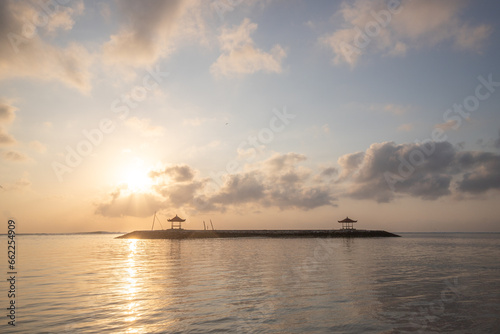 Landscape shot in Bali. Sunrise or sunset at Sanur beach. Beautiful sandy beach in the morning, with fine sand and a view of the calm sea. Temples are in the water. A dream in Indonesia © Jan