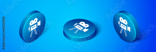 Isometric Retro cinema camera icon isolated on blue background. Video camera. Movie sign. Film projector. Blue circle button. Vector