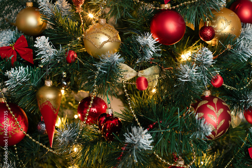 Red and golden baubles on christmas tree for background. New Year concept.