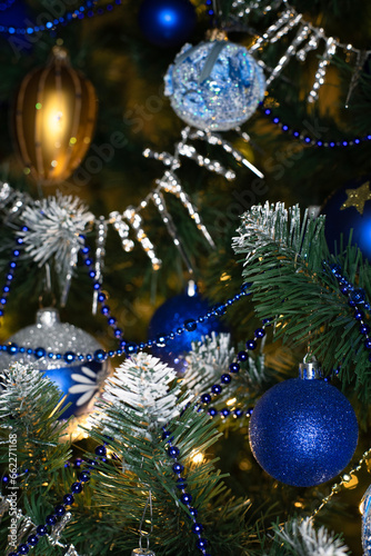 Blue and silver baubles on christmas tree for background. New Year concept.