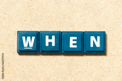 Tile alphabet letter in word when on wood background