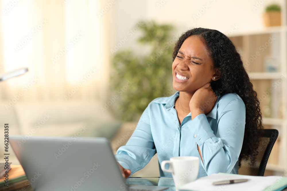 Black teleworker suffering neck ache Black teleworker suffering neck ache
