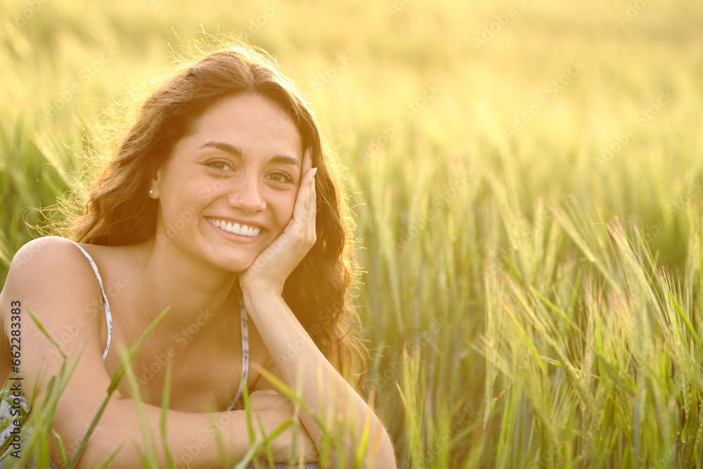 Happy woman in wheat field smiling at camera Happy woman in wheat field smiling at camera