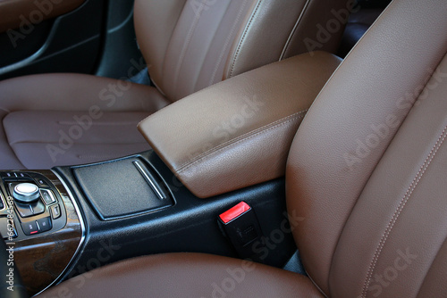 Modern premium car armrest. Lux Car inside. Premium car interior with light brown high-tech comfortable seats. Interior of prestige car. Comfortable perforated leather seats. © Best Auto Photo
