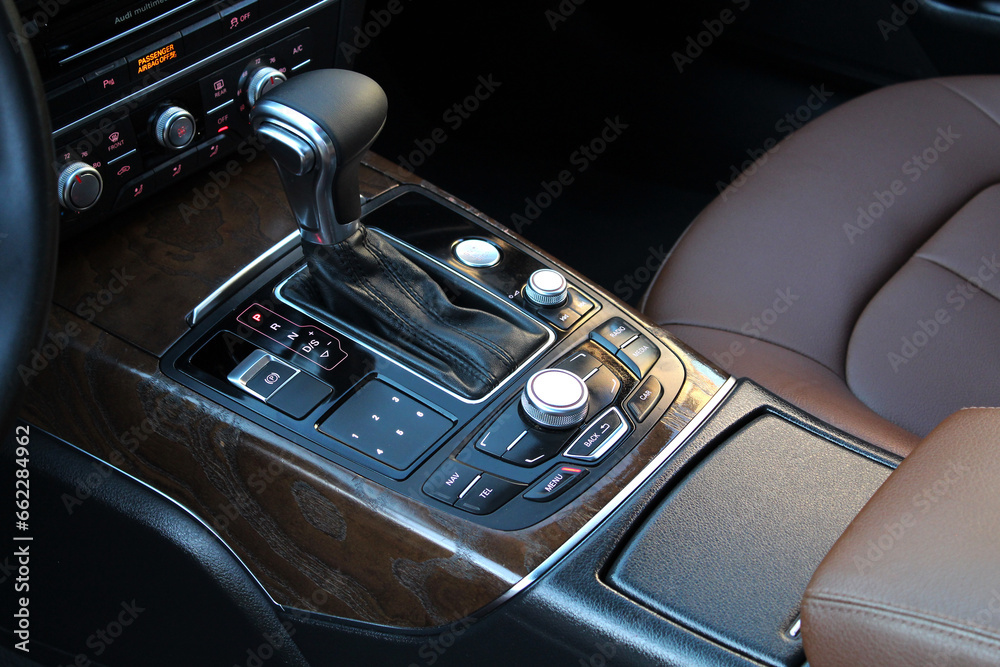 Gear lever. Automatic transmission lever shift. Modern car Center console. Modern luxury car brown leather interior.