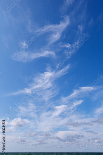 Beautiful blue sky over the sea with translucent  white  Cirrus clouds